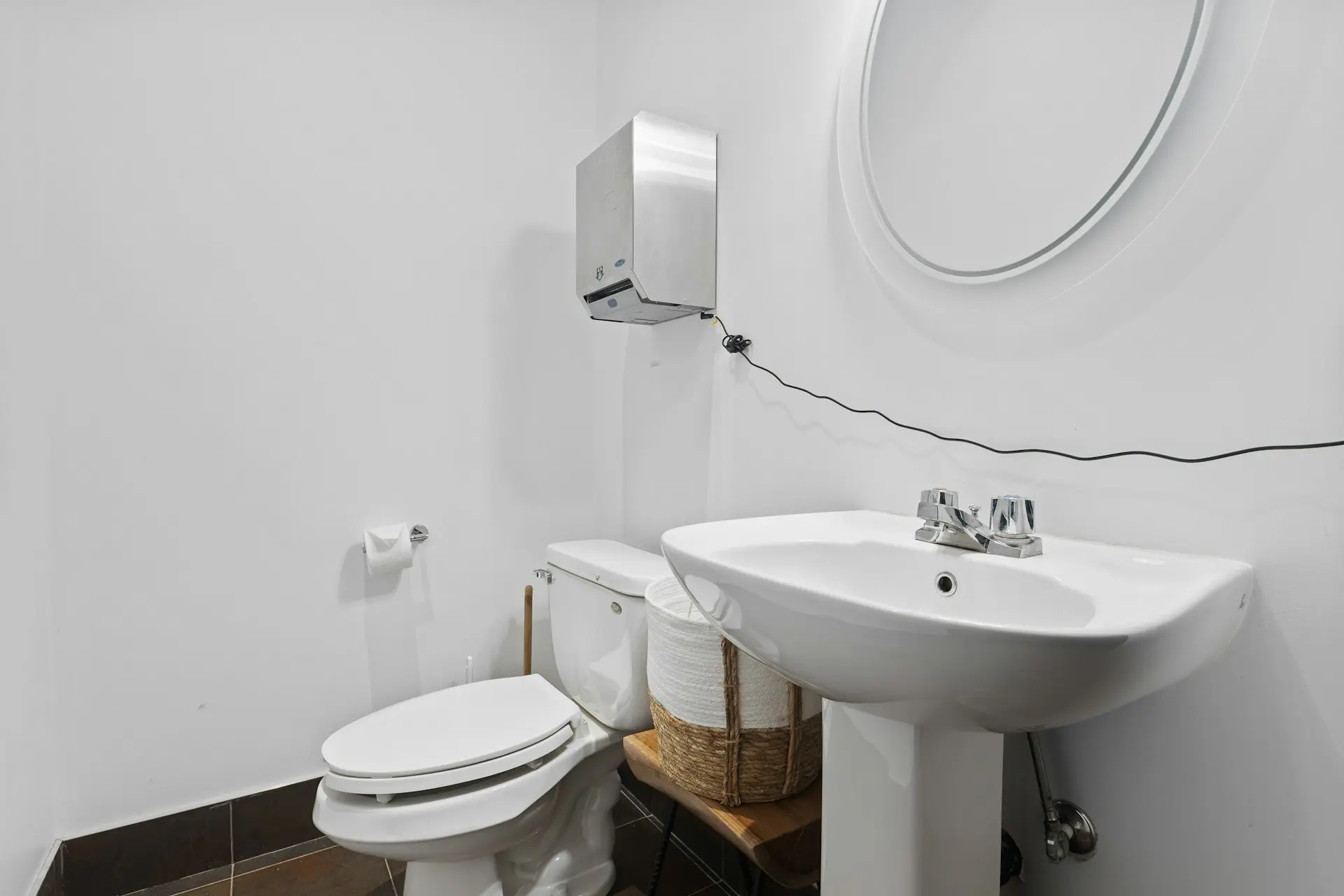 a bathroom with a sink toilet and mirror